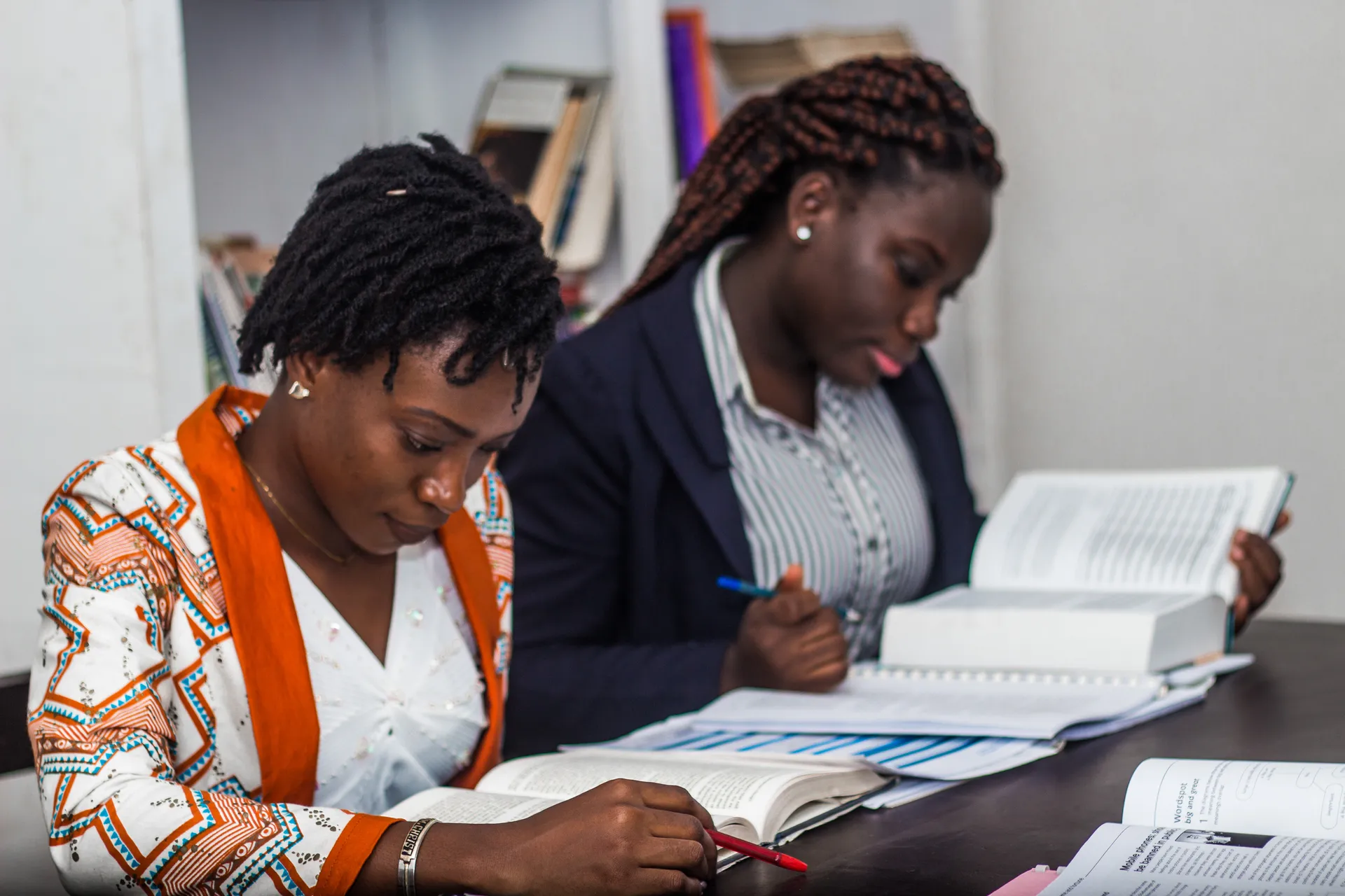 African Vision International University students studying together in a library